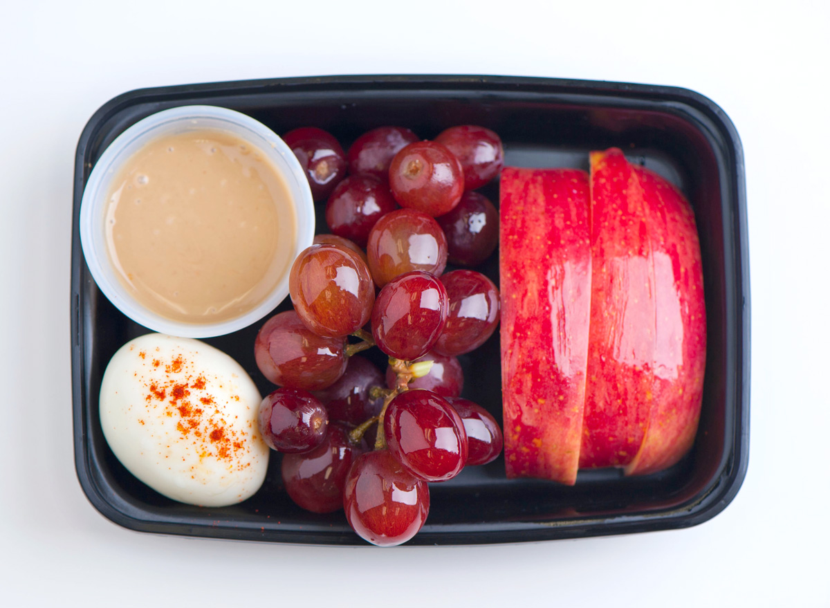 https://www.eatthis.com/wp-content/uploads/sites/4/2016/02/protein-snack-box-apples-grapes-peanut-butter-hard-boiled-egg.jpg?quality=82&strip=1