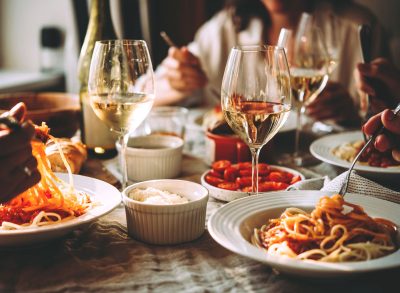 Friends eating a pasta dinner at a restaurant