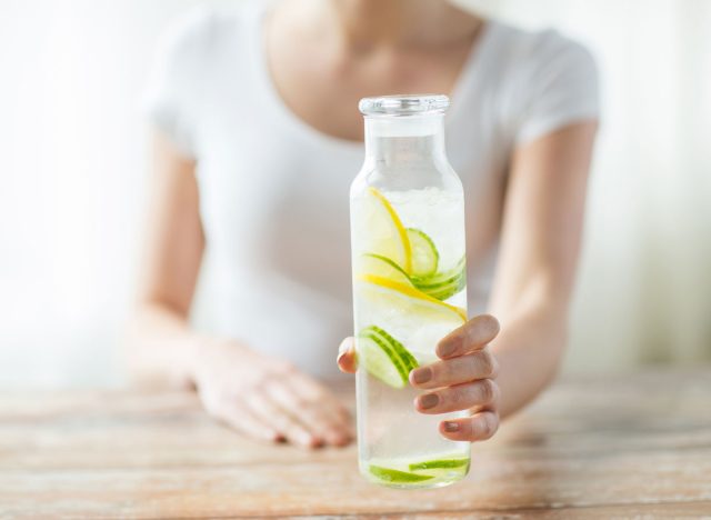 https://www.eatthis.com/wp-content/uploads/sites/4/2018/11/woman-holding-lemon-cucumber-water.jpg?quality=82&strip=all&w=640