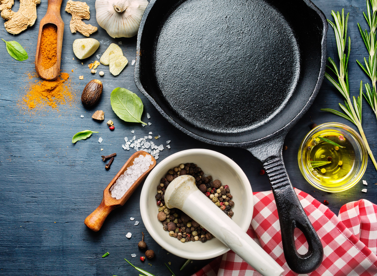 https://www.eatthis.com/wp-content/uploads/sites/4/2018/12/cast-iron-skillet-herbs-spices.jpg