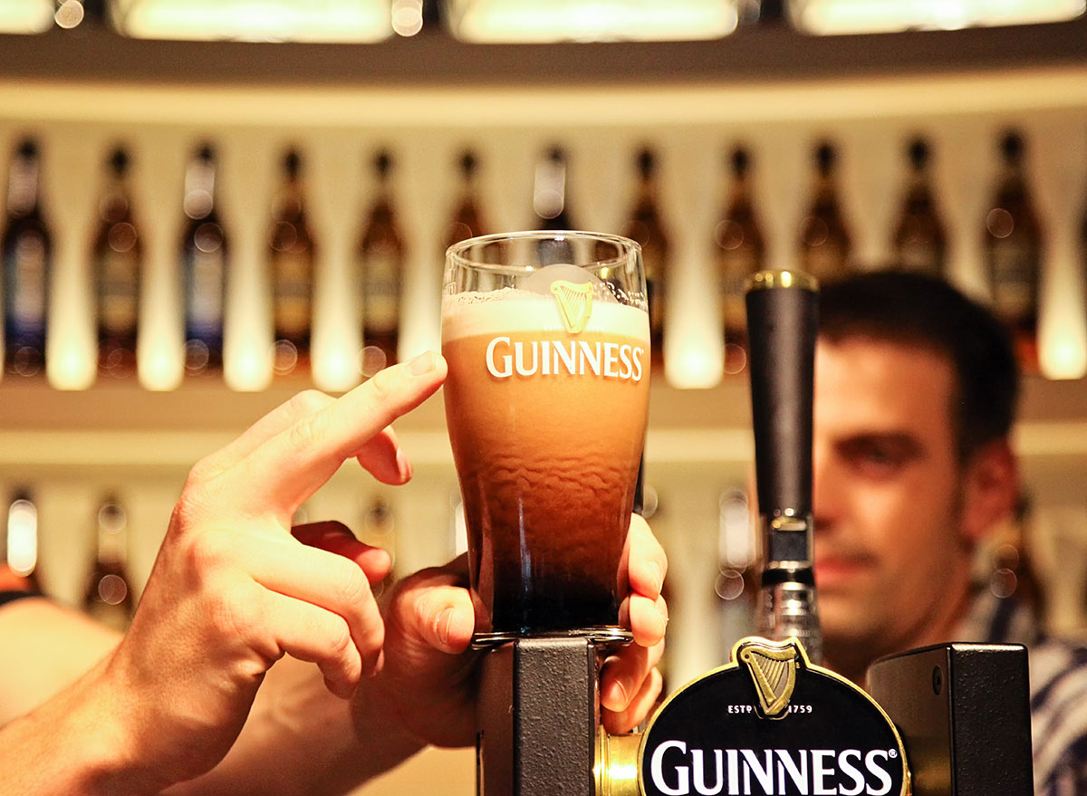 poured guinness in glass with red tint