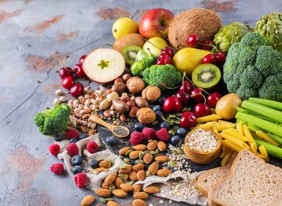 a spread of various vegetables, fruits, nuts and oats