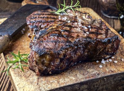 dry ages barbecue porterhouse steak on cutting block