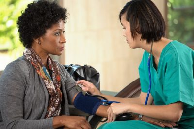 Nurse taking a patients blood pressure