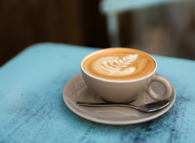 light brown hot fresh mocha on light blue table