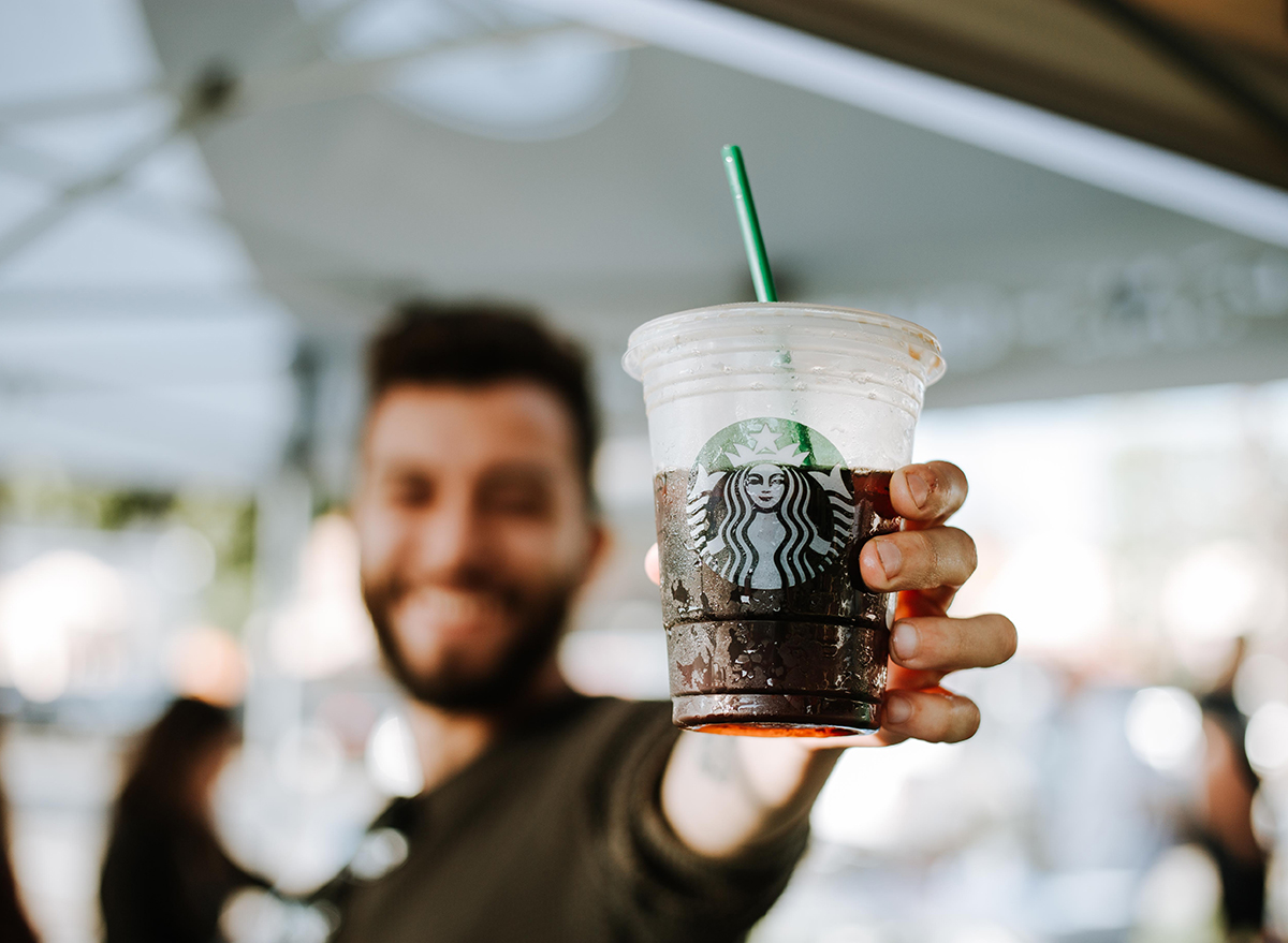 https://www.eatthis.com/wp-content/uploads/sites/4/2019/09/starbucks-customer-holding-iced-coffee.jpg?quality=82&strip=1