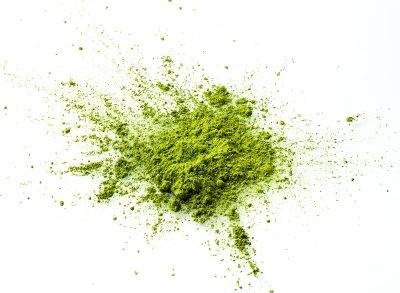 loose matcha powder on white background