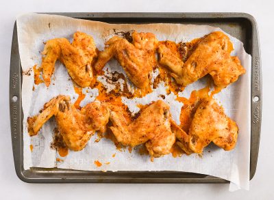 finished chicken wings with blue cheese dip and celery on a plate