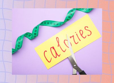 cutting calories concept of scissors cutting a piece of paper with the word calories