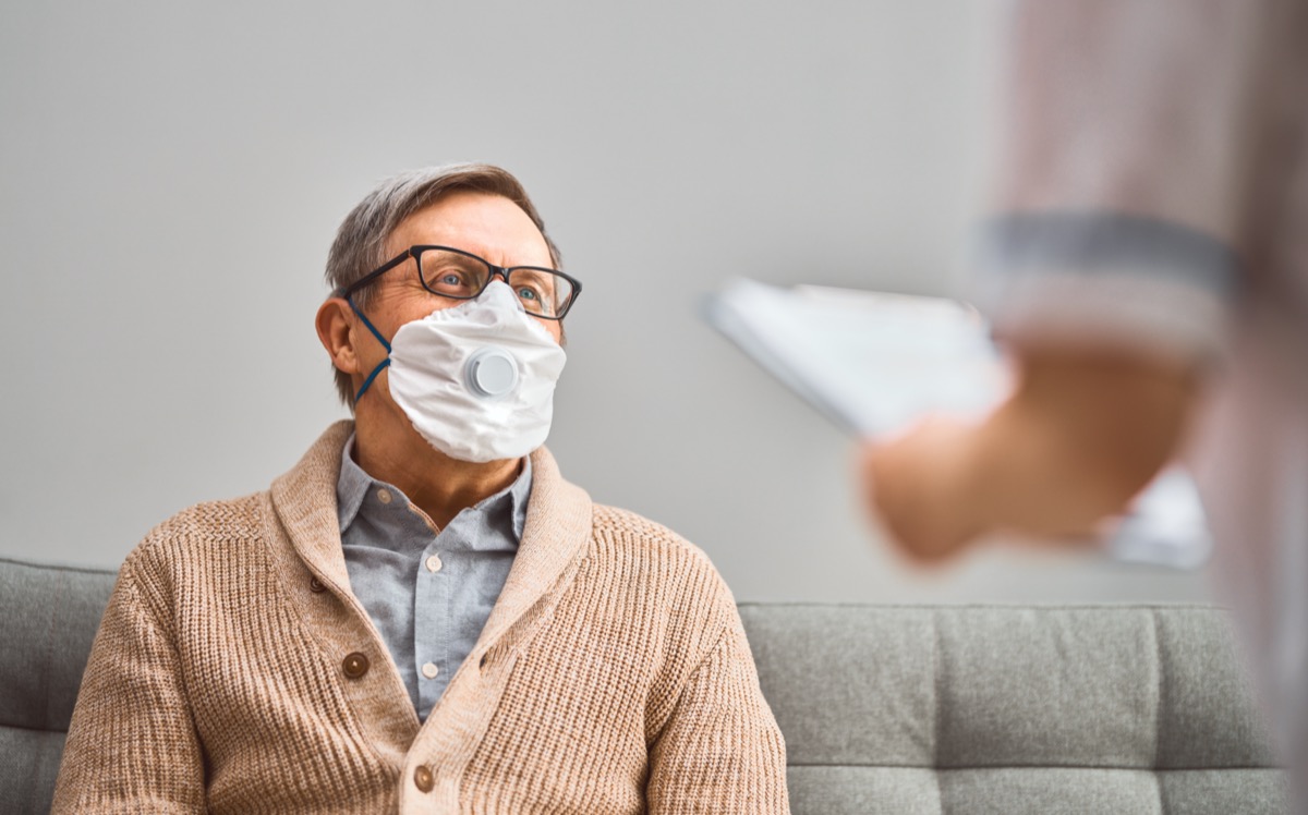 Doctor and senior man wear face masks during coronavirus and flu outbreak