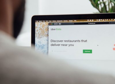 man ordering uber eats online on laptop