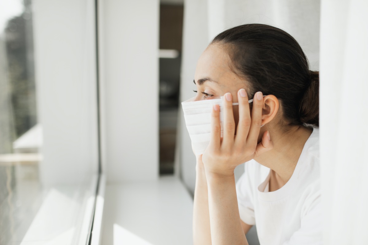 mask looking through window. Important job and self isolation during coronavirus pandemic.