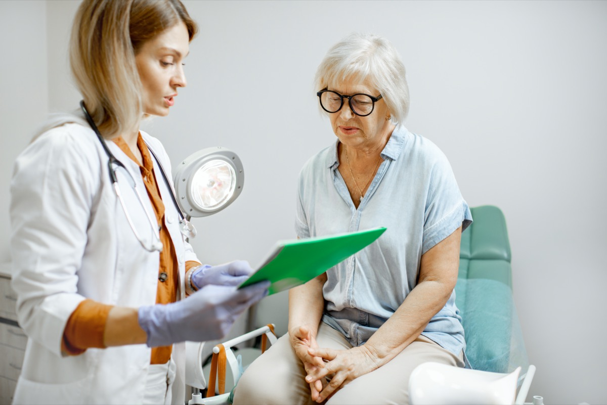 Senior woman sitting on the gynecological chair during a medical consultation with gynecologist