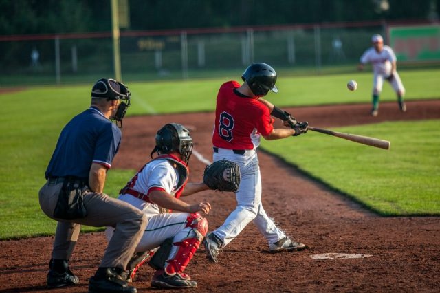 Baseball batter hits the ball