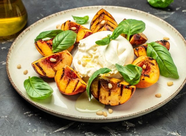 plate of burrata and grilled peaches