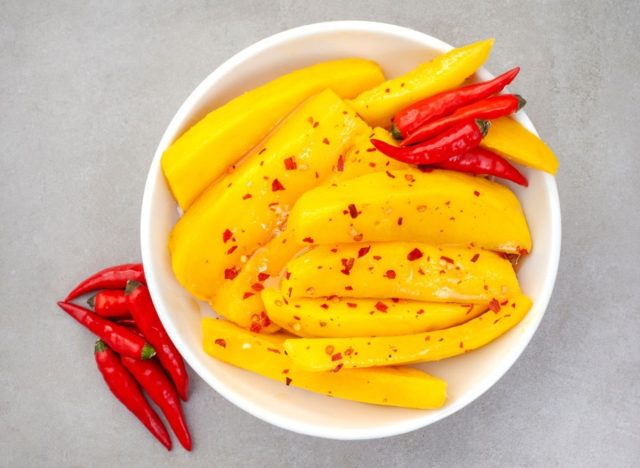 slices of mango with chili flakes in a bowl
