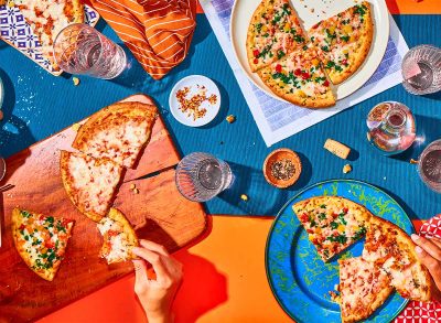 frozen pizzas on cutting boards and plates