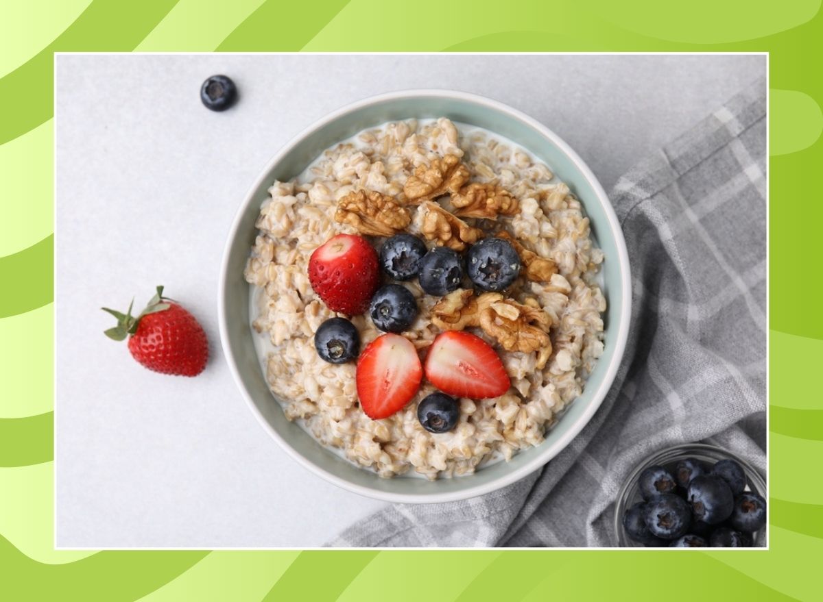 bowl of oatmeal with nuts and berries on a green background