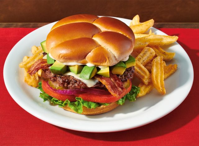 Denny's Bacon Cheeseburger on a plate and red counter