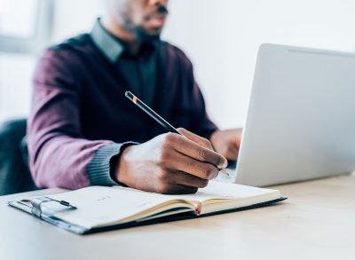 person writing in notebook