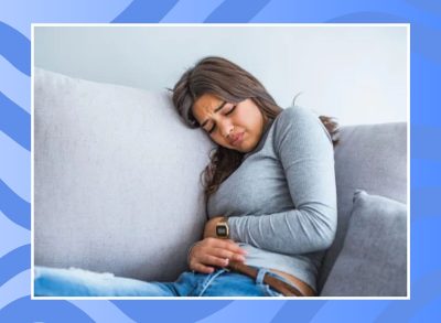 woman sitting down with stomach pain