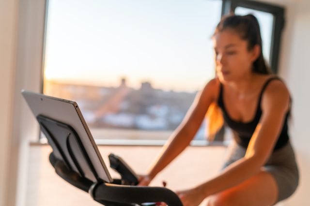 woman at home with an exercise bike