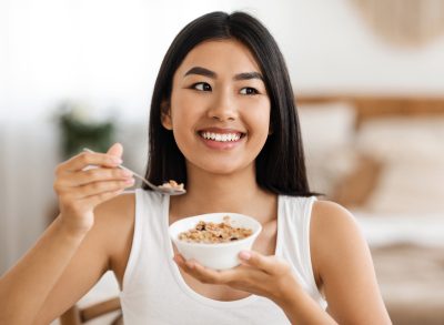 woman eating oatmeal happy