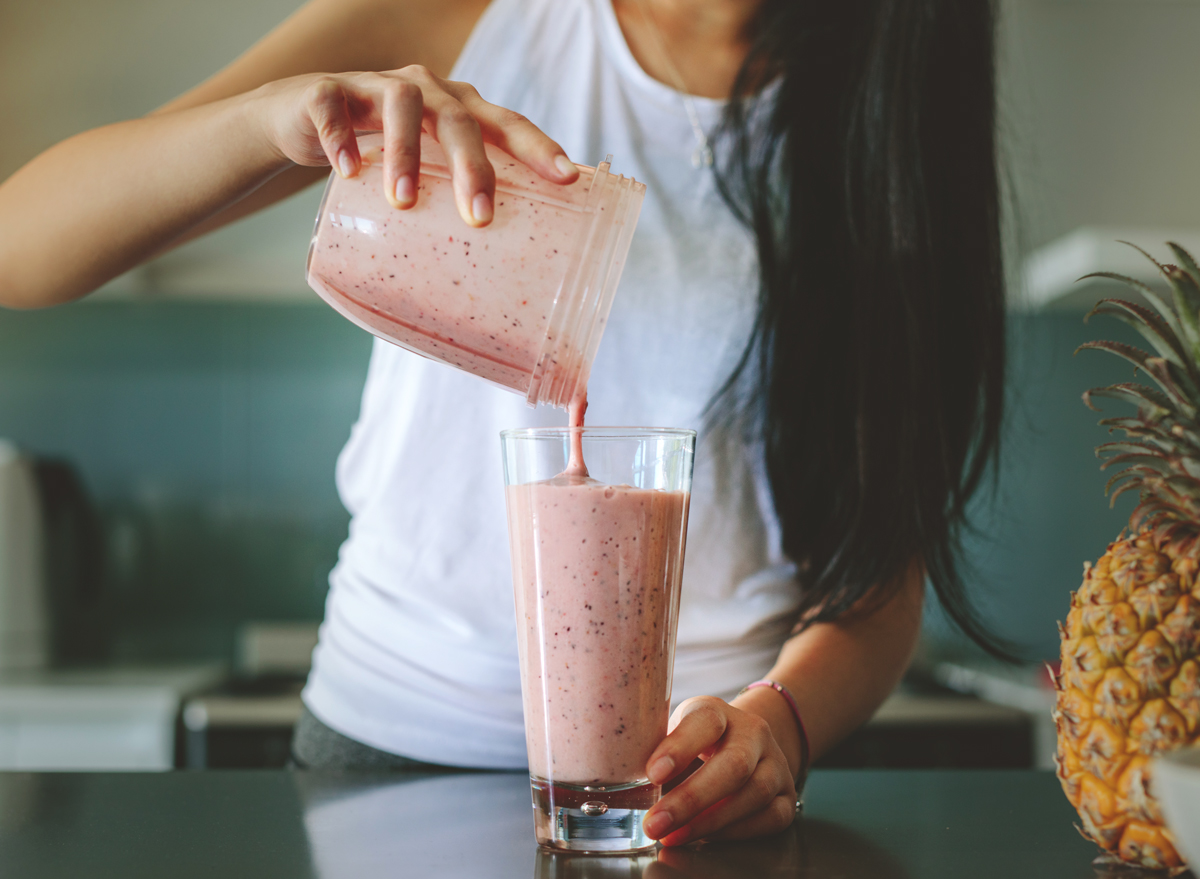 https://www.eatthis.com/wp-content/uploads/sites/4/2021/03/woman-pouring-smoothie-glass.jpg?quality=82&strip=1