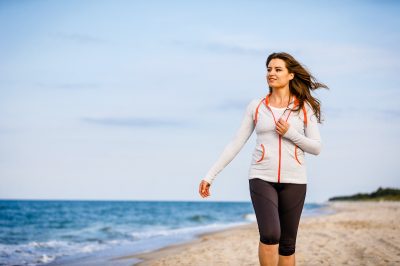 Young woman walking on beach