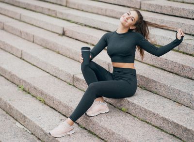 woman drinking coffee on stairs