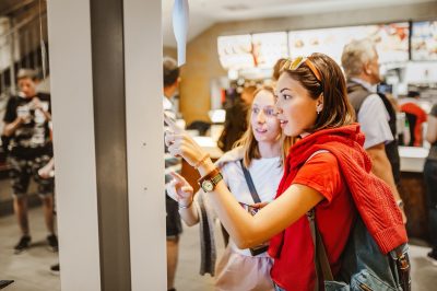 women ordering fast food on electronic menu