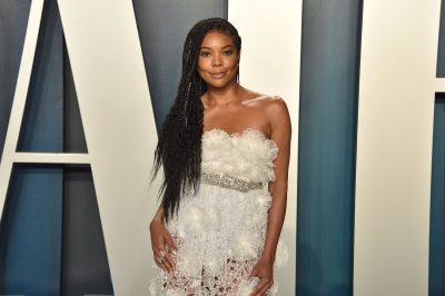 gabrielle union in white lace and ruffled dress on vanity fair red carpet