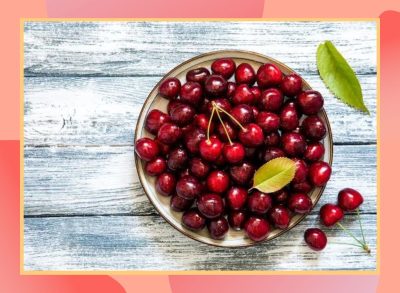 a photo of a bowl of cherries on a designed background