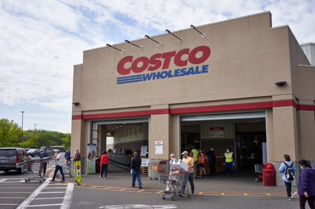 Masked shoppers outside a Costco store