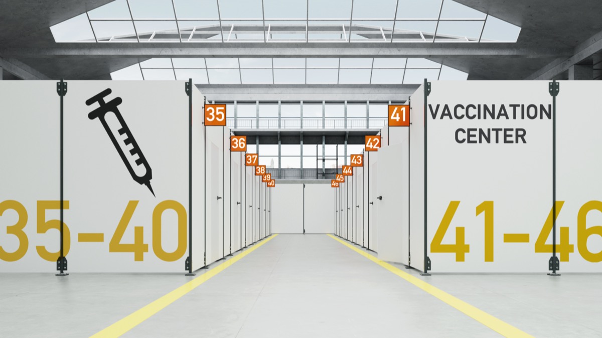 Corona temporary vaccination center in a warehouse with booths.