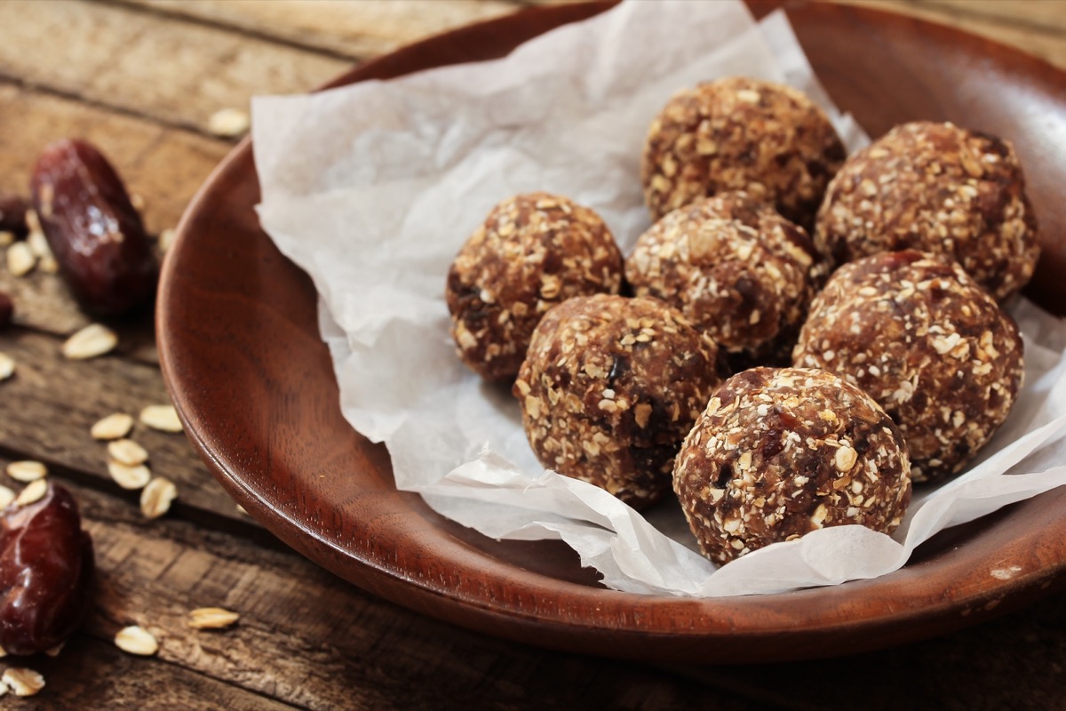 energy balls on pergamin paper inside wooden bowl