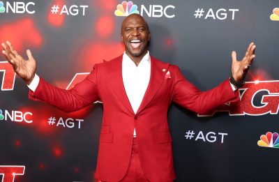 terry crews in red suit on red carpet