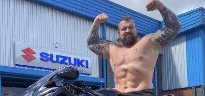 eddie hall sitting on a motorcycle