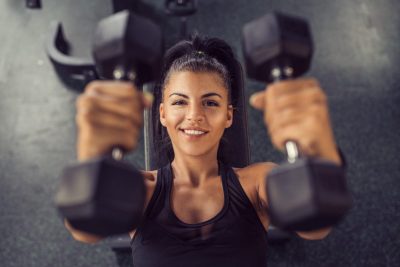 happy woman smiling gym weights