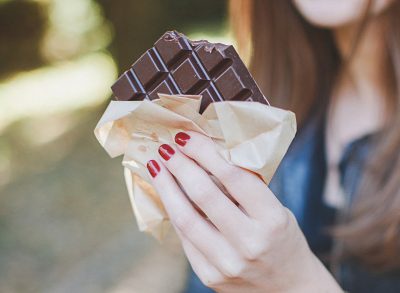 holding a dark chocolate bar