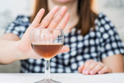 woman refusing glass of alcohol