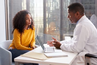 doctor and patient having a somber conversation