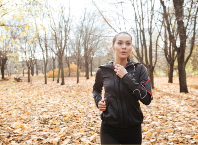 woman running in nature in the cold weather