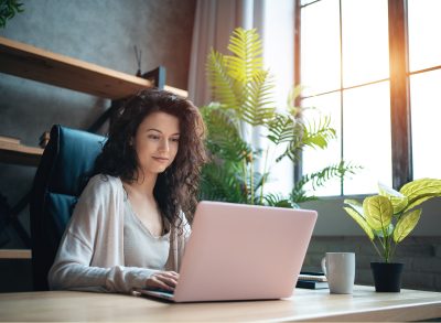 woman typing on laptop in home office