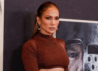 Jennifer Lopez poses in brown sparkly top and skirt at event