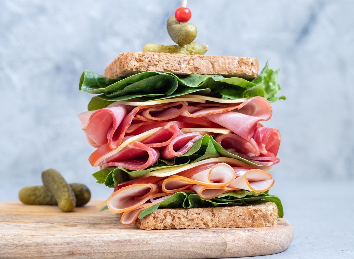 https://www.eatthis.com/wp-content/uploads/sites/4/2022/01/stacked-sandwich-cold-cuts.jpg?quality=82&strip=1
