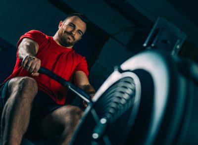 fit man using a rowing machine