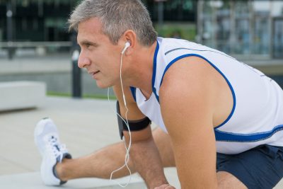 mature man stretching before outdoor exercise