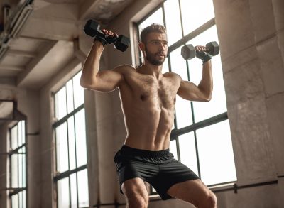 man performing dumbbell squat