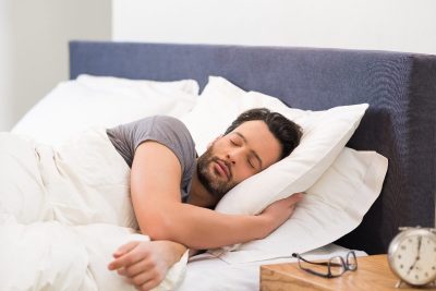 man sleeping in bright room